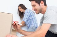 Couple marking what belongings are in what box