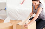 Woman taping box shut