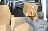 Moving man stacking boxes